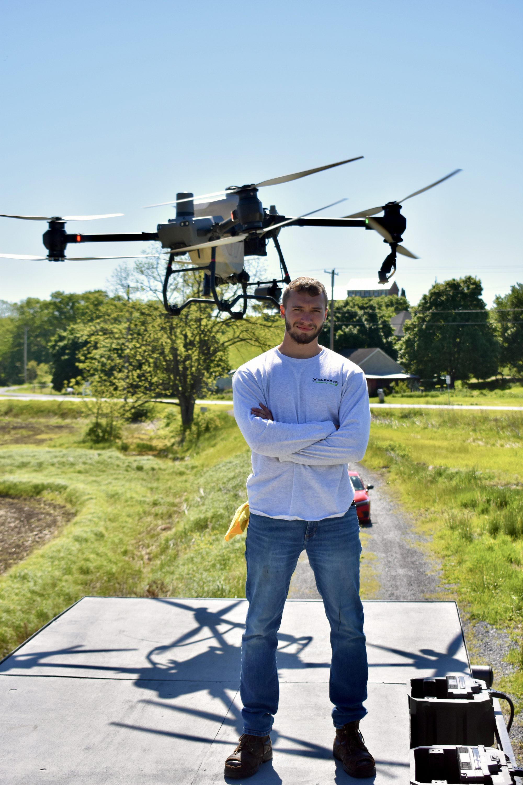 Owner standing under drone in flight